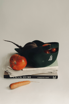 fullfilled Cap on books and vegetables in Berlin, turned upside down