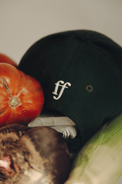 fullfilled Cap on books and vegetables in Berlin, closeup